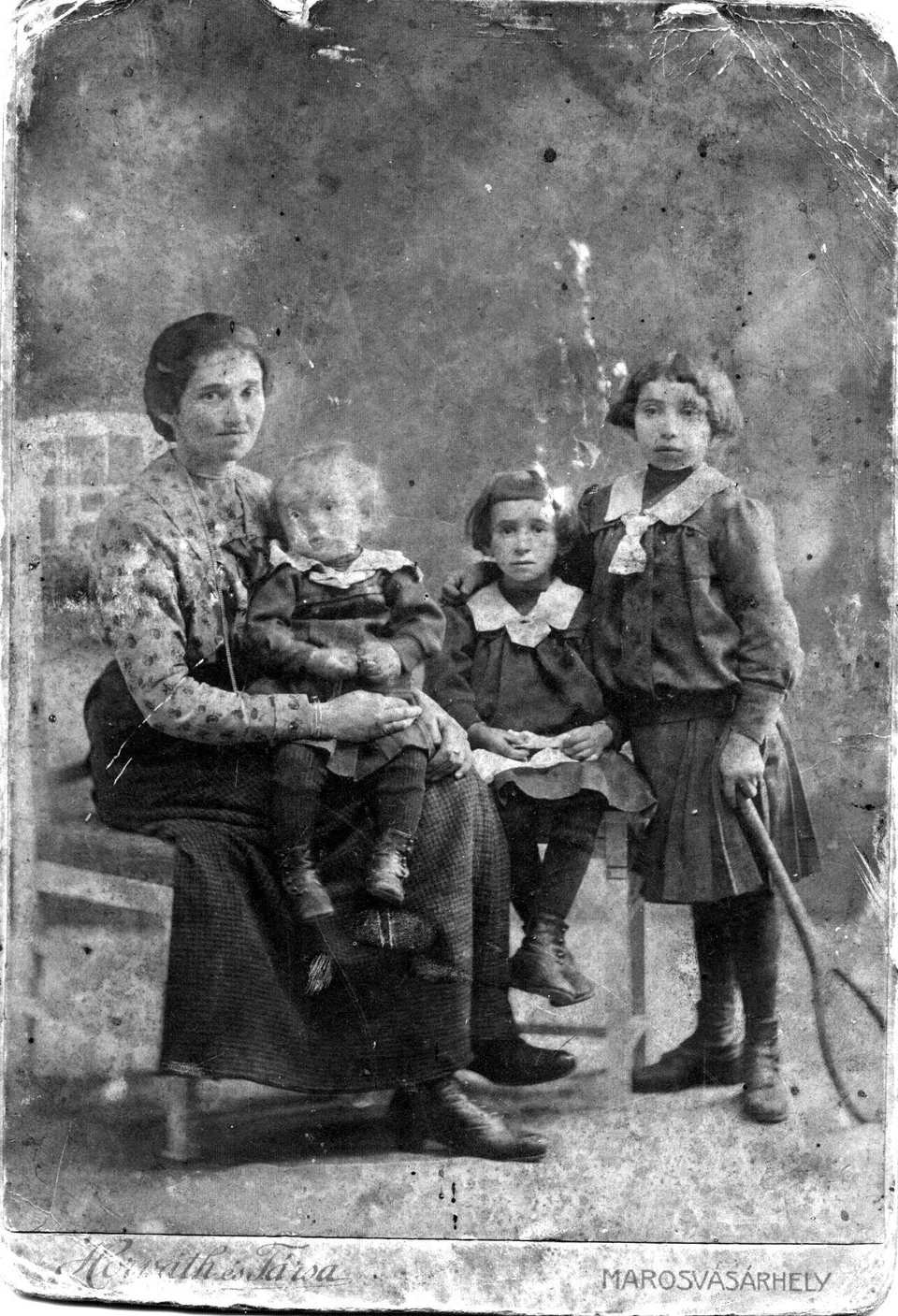 Emil as a small child seated with his mother and his two older sisters, Regi and Judith.