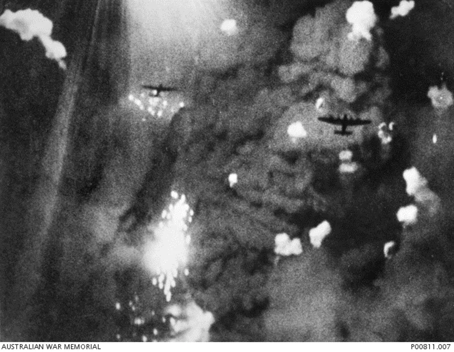 An aircraft silhouetted amid explosions during an Allied raid on Lützkendorf.