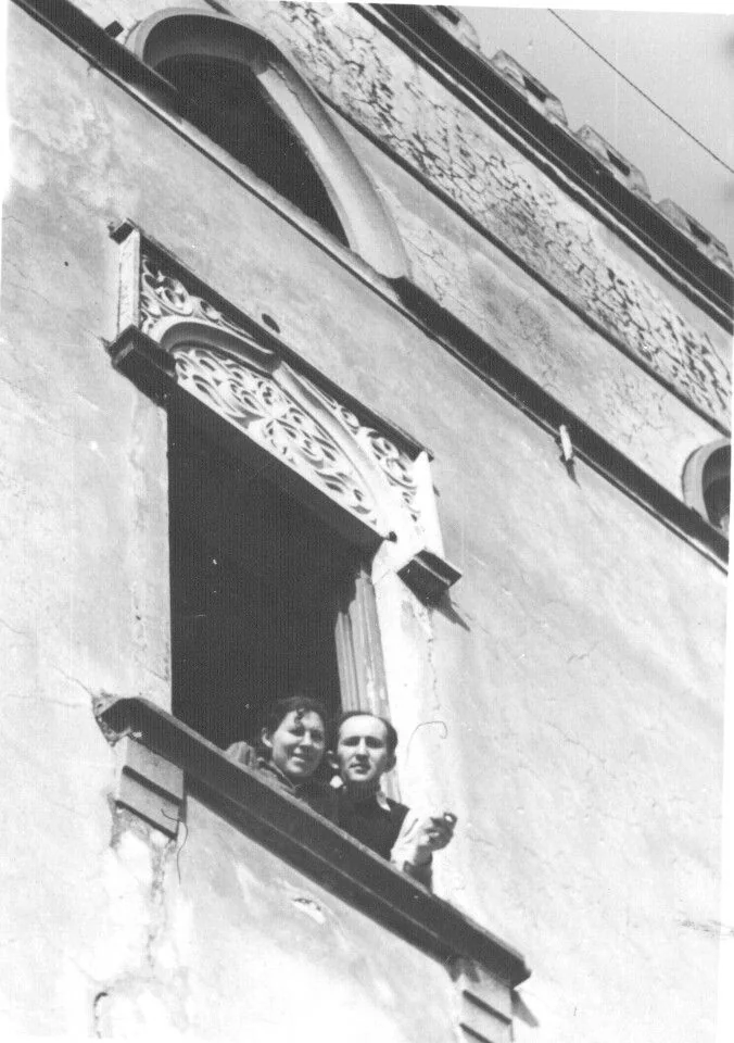 Masha and Aryeh looking out together from a window in Italy.
